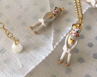 Cute and tiny  porcelain doll necklace with a gold heart and a vermeil chain