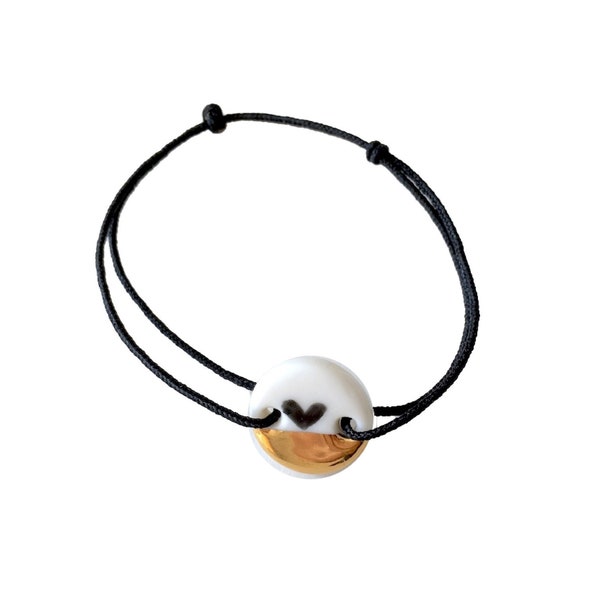 Simply Lovely porcelain bracelet with cute patterns. black heart with gold on white porcelain bracelet