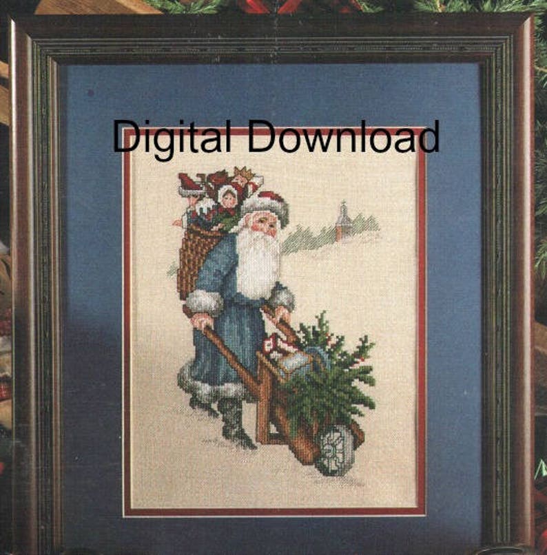 May include: A cross-stitch pattern featuring a blue-clad Santa Claus pushing a wheelbarrow full of presents and a Christmas tree. The scene is set against a snowy background with a church in the distance. The text "Digital Download" is displayed above the image.