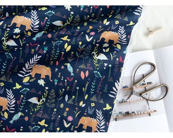 May include: A dark blue fabric with a repeating pattern of elephants, birds, and flowers. The elephants are orange and have floral crowns. The birds are colorful and the flowers are pink, yellow, and blue.