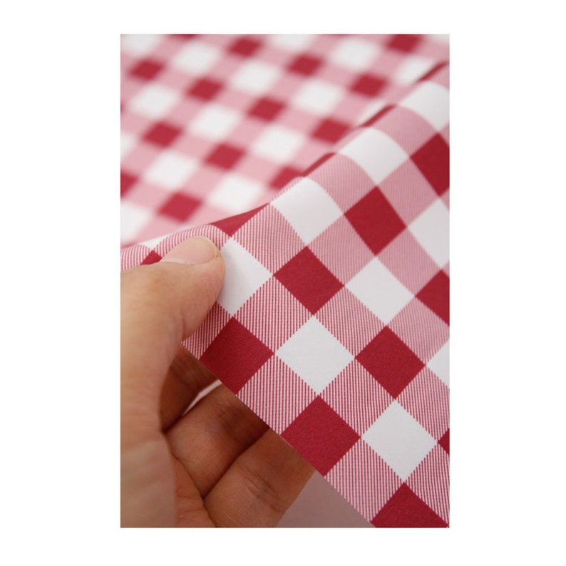 May include: Red and white checkered fabric with a fine woven texture. The fabric is folded in half, showing the underside.