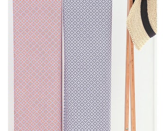 May include: Two fabric samples with a geometric pattern. The fabric on the left has a white background with a red diamond pattern. The fabric on the right has a white background with a blue diamond pattern.