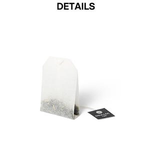 May include: A white tea bag with a string and a small black tag. The tea bag is filled with loose tea leaves. The tag reads "OSULLOC" in white text. The word "DETAILS" is at the top of the image.