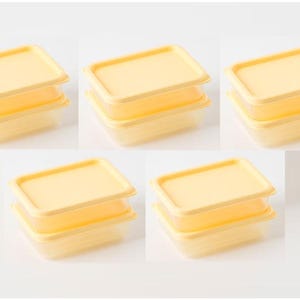 May include: Five sets of small, rectangular, yellow food storage containers with matching lids. Each set includes two containers stacked on top of each other. The containers are made of a translucent material.