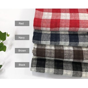 May include: Four fabric swatches in red, navy, brown, and black gingham patterns. Each swatch is folded in half and stacked on top of each other.