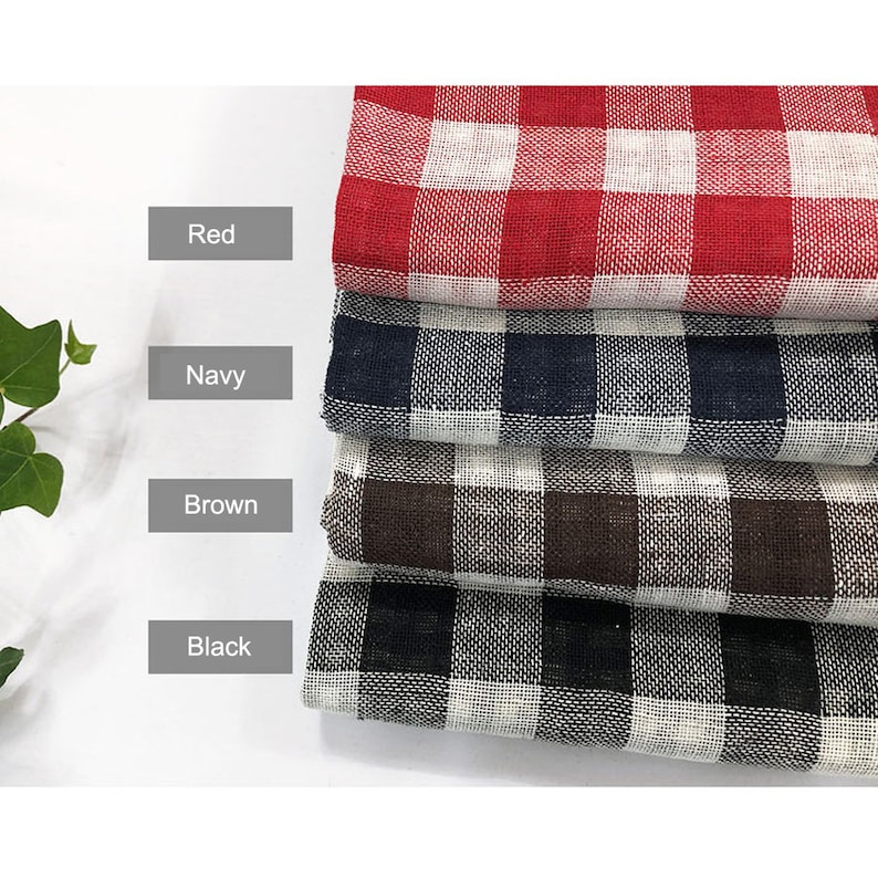 May include: Four fabric swatches in red, navy, brown, and black gingham patterns. Each swatch is folded in half and stacked on top of each other.