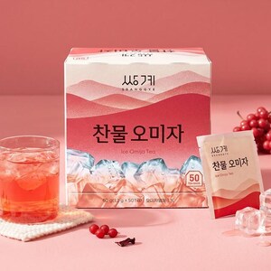 May include: A rectangular box of Ssanggye Ice Omija Tea with a pink gradient design featuring mountain silhouettes and ice cubes. The box contains 50 tea bags, totaling 60 grams. A single tea bag packet and a glass of red tea with ice are included.