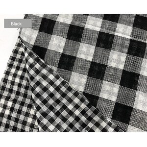 May include: Black and white checkered fabric with a larger checkered pattern on top. The fabric is woven and has a slightly textured surface.