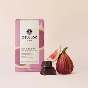 May include: A box of Osulloc Fig Chocolat Black Tea with a pink and purple design. The box features a graphic of a fig and chocolate. The text on the box reads "Osulloc", "Fig Chocolat Black Tea", and "40g (2.0 g x 20EA) 120 Tea Bags NET WT. 1.41 oz".