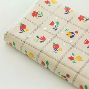 May include: A beige fabric with a repeating pattern of red, yellow, and green flowers in a grid. The fabric is waterproof and has a subtle dotted texture.