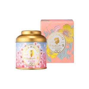 May include: A round, gold-lidded tin with a blue and pink gradient background, adorned with cherry blossom illustrations. The tin features the text "GOLD JUBILEE" and "50th Anniversary". A matching box with floral designs is also present.
