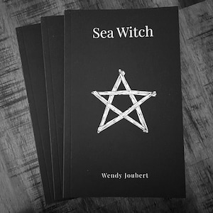 May include: Three identical black paperback books stacked slightly offset. The front cover features the white text Sea Witch at the top and Wendy Joubert at the bottom, with a central white graphic illustration of a five-pointed star made of twigs.