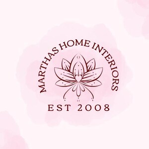 May include: A logo for "MARTHAS HOME INTERIORS" with a dark red-brown lotus flower design at its centre. The text is arranged in a semi-circle around the flower, with "EST 2008" below. The background has a soft pink watercolour effect.