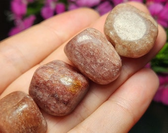 May include: Four tumbled stones with a reddish-brown and white striped pattern. The stones are smooth and polished.
