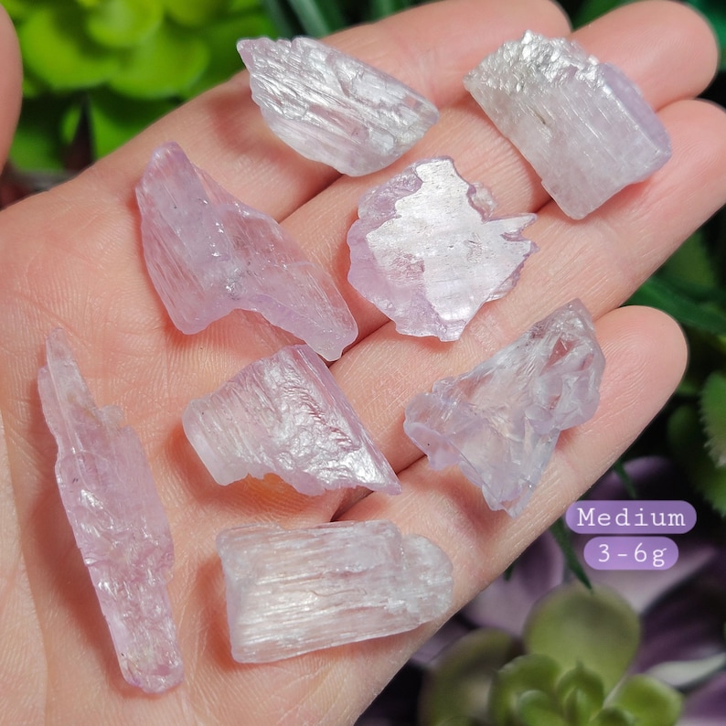 May include: A collection of seven light purple selenite crystal points, ranging in size from small to medium. The crystals are translucent and have a slightly iridescent sheen.  Medium 3-6g