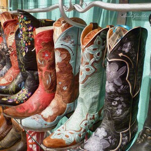 May include: A collection of colorful embroidered cowboy boots with floral designs. The boots are arranged in a row, with the toes pointing towards the viewer. The boots are all different colors, including red, blue, green, and brown. The boots are all decorated with intricate embroidery, featuring flowers, leaves, and other designs.