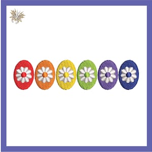 May include: Seven embroidered Easter eggs in a rainbow of colors with white daisy flowers in the center.