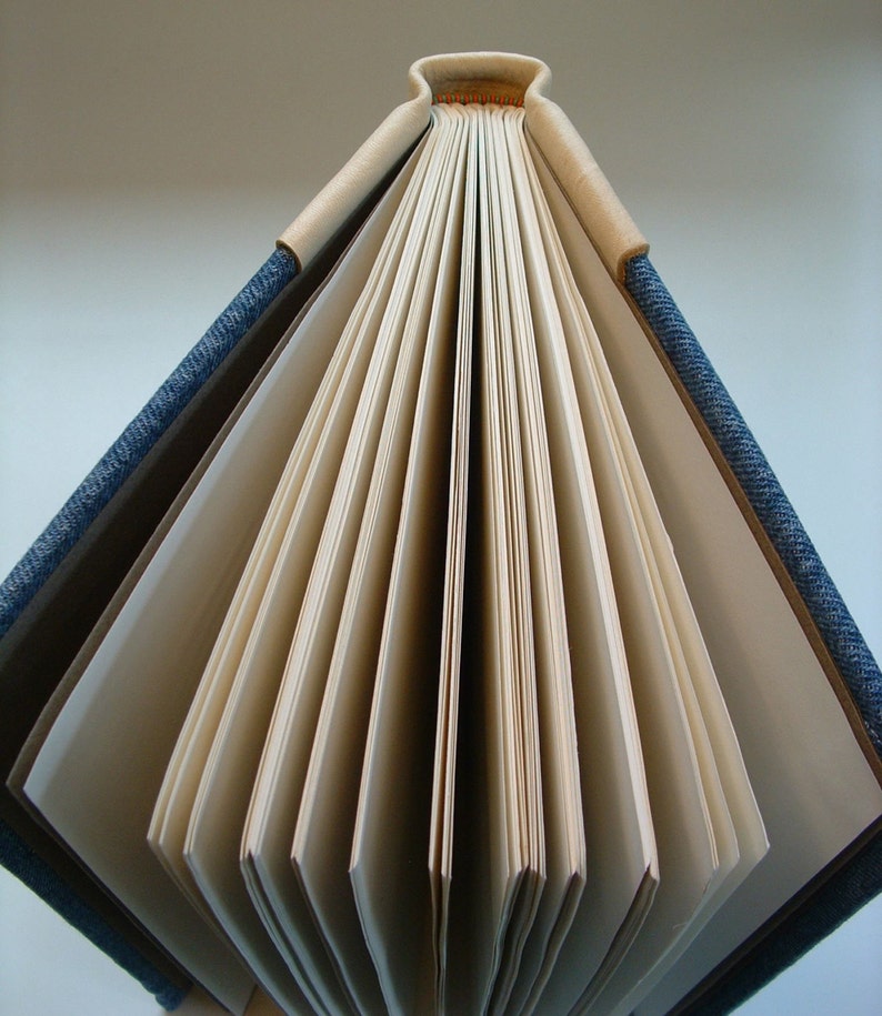 A fine handmade book bound in denim and soft cowhide. Etsy