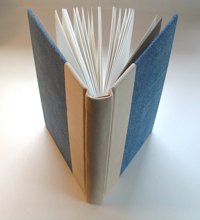 A fine handmade book bound in denim and soft cowhide. Etsy