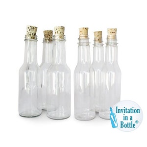 May include: Six clear glass bottles with cork stoppers. The bottles are empty and have a narrow neck and a rounded body. The corks are a light brown colour. A white and blue logo that says "Invitation in a Bottle" is in the bottom right corner.