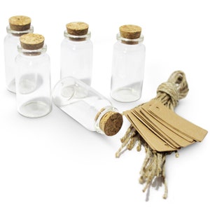May include: Five small clear glass bottles with cork stoppers and a bundle of brown twine and blank brown paper tags.
