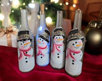 Hand painted bottle with a Snowman and fairy lights, frosted white glass. Lights included.