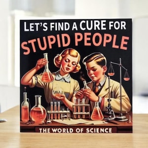 May include: A vintage-style print with the text "LET'S FIND A CURE FOR STUPID PEOPLE" in white and orange. The image features two young scientists in lab coats, flasks, and test tubes, with the words "THE WORLD OF SCIENCE" at the bottom.