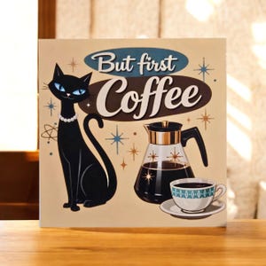 May include: A retro-style sign with the text "But first Coffee". It features a black cat with blue eyes and a pearl necklace, a coffee pot, and a cup of coffee. The background is beige with starburst accents.