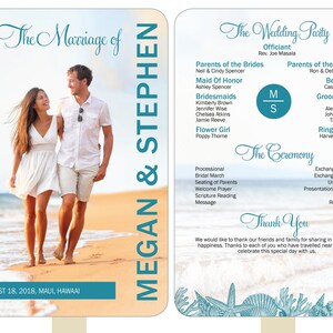 May include: A wedding program fan with a beach scene background. The fan features a photo of a couple walking on a beach, the wedding party names, and the ceremony details. The text on the fan reads "The Marriage of Megan & Stephen" and "The Wedding Party".