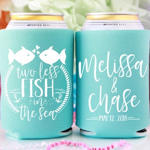 May include: Two turquoise blue can coolers with white text. One cooler says "two less fish in the sea" with a graphic of two fish kissing. The other cooler says "Melissa & Chase" with the date "May 12, 2018".