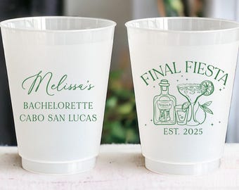 May include: Two translucent plastic cups. One cup has the text "Melissa's Bachelorette Cabo San Lucas" in green script. The other cup has a green graphic of a tequila bottle, margarita, lime, and the words "Final Fiesta Est. 2025".