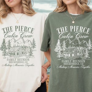 Pu&ograve; includere: Due magliette a maniche corte, una color crema e una verde oliva, ciascuna con una grafica che recita "THE PIERCE Cabin Crew FAMILY REUNION BRECKENRIDGE, CO Making Memories Together". Il design presenta una baita, alberi e montagne.