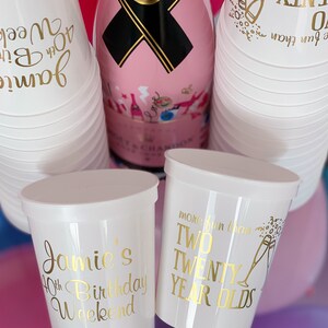 May include: White plastic cups with gold lettering. One cup says "Jamie's 40th Birthday Weekend". Another cup says "More fun than two twenty year olds".