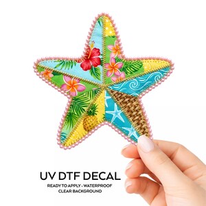 May include: A colorful, star-shaped UV DTF decal with a tropical floral design. The decal features a patchwork of patterns including hibiscus flowers, pineapples, and palm leaves. The edges are lined with pink beads. The text "UV DTF DECAL" is visible.