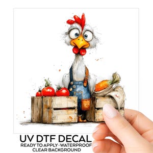 May include: A UV DTF decal featuring a cartoon chicken with wide eyes, a red comb, and a yellow beak, wearing blue denim overalls. The chicken stands behind two wooden crates filled with red tomatoes and a carrot. Text reads UV DTF DECAL.