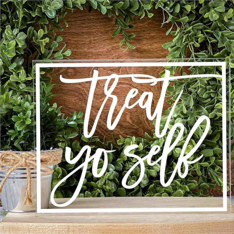 May include: White acrylic sign with a white border and the text "treat yo self" in a handwritten font.