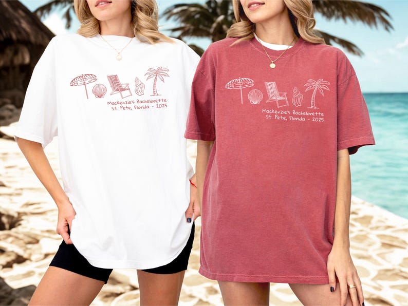 May include: Two oversized t-shirts, one white and one red, featuring a beach-themed graphic in red ink. The design includes an umbrella, seashell, beach chair, ice cream cone, and palm tree. Text reads "Mackenzie's Bachelorette St. Pete, Florida - 2025".