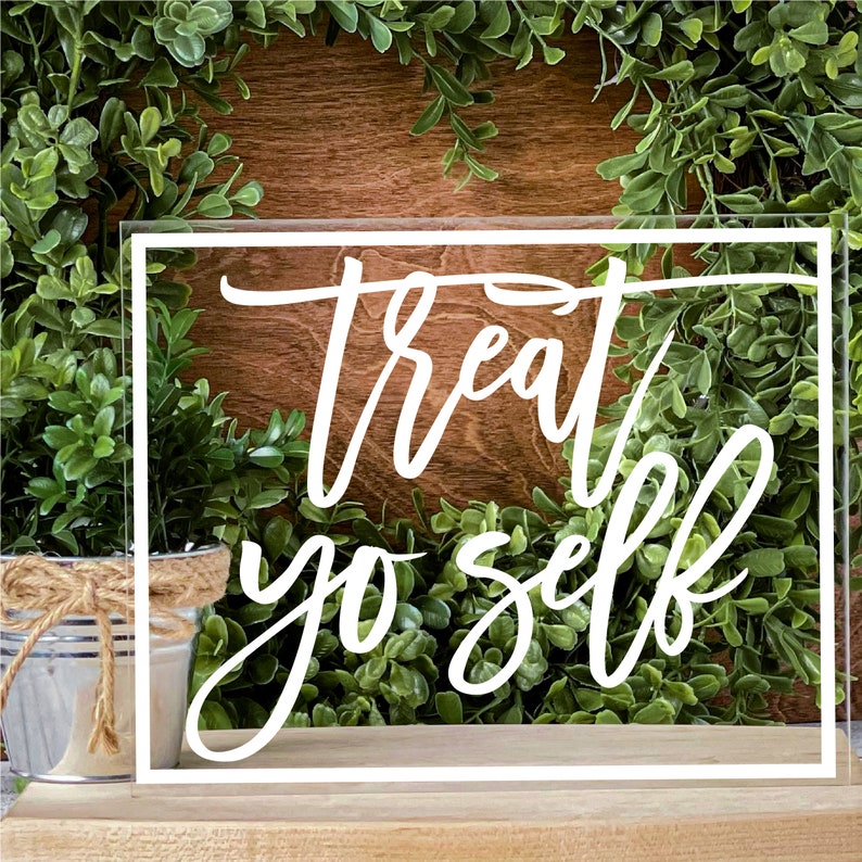 May include: White acrylic sign with a white border and the text "treat yo self" in a handwritten font.