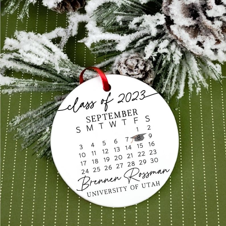 May include: White round bauble with black text that reads "class of 2023", "SEPTEMBER", "SMTWTFS", "1 2", "3 4 5 6 7 8 9", "10 11 12 13 14 15 16", "17 18 19 20 21 22 23", "24 25 26 27 28 29 30", "Brennen Rossman", and "UNIVERSITY OF UTAH".