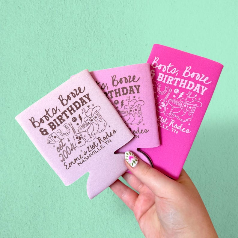 May include: Three pink and light pink can coolers with the text "Boots, Booze & Birthday" and a cowboy-themed graphic. The coolers also feature the text "Emme's 21st Rodeo, Nashville, TN".