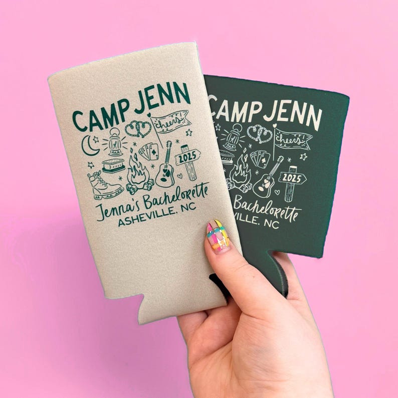 May include: Two foam can coolers, one light beige and one dark green, featuring the text CAMP JENN, Jenna's Bachelorette, and ASHEVILLE, NC. The graphic design includes illustrations of a lantern, campfire, guitar, playing cards, and a sign with 2025.