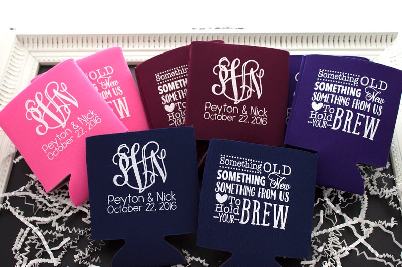 May include: Set of six personalized can coolers in pink, purple, navy blue, and burgundy. The coolers feature a monogram and the text "Something Old, Something New, Something From Us, To Hold Your Brew".