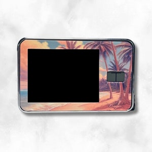 May include: A medical device with a beach scene design. The device features a black screen and two buttons. The beach scene includes palm trees, sand, and a sunset with shades of pink, orange, and blue.
