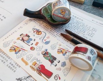 May include: Washi tape rolls with illustrations of characters and scenes from a story, and matching stickers. The tape is displayed on a book with Chinese text, a ceramic dish, and paint brushes. The tape is approximately 1.5 cm wide.