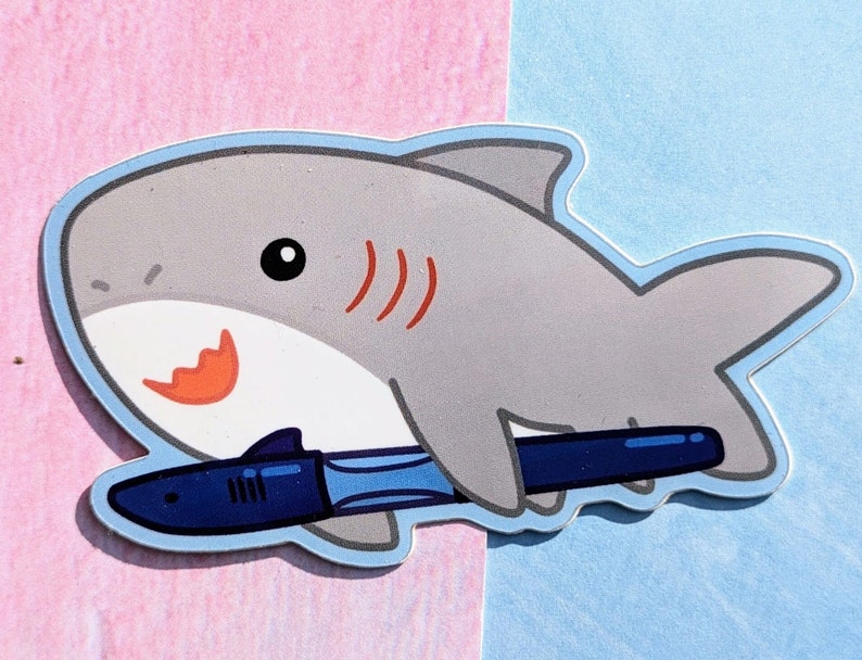 A cartoon shark holding a Jinhao shark fountain pen. The fountain pen has the head and fin of a shark and is made of blue plastic.