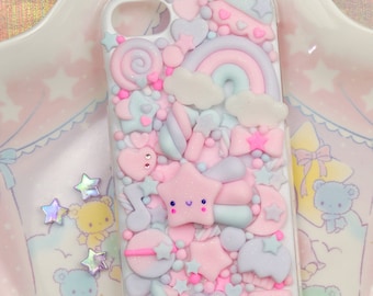 May include: A pink, blue and white phone case with a rainbow, stars, hearts and other cute designs. The case is made of resin and has a glossy finish.