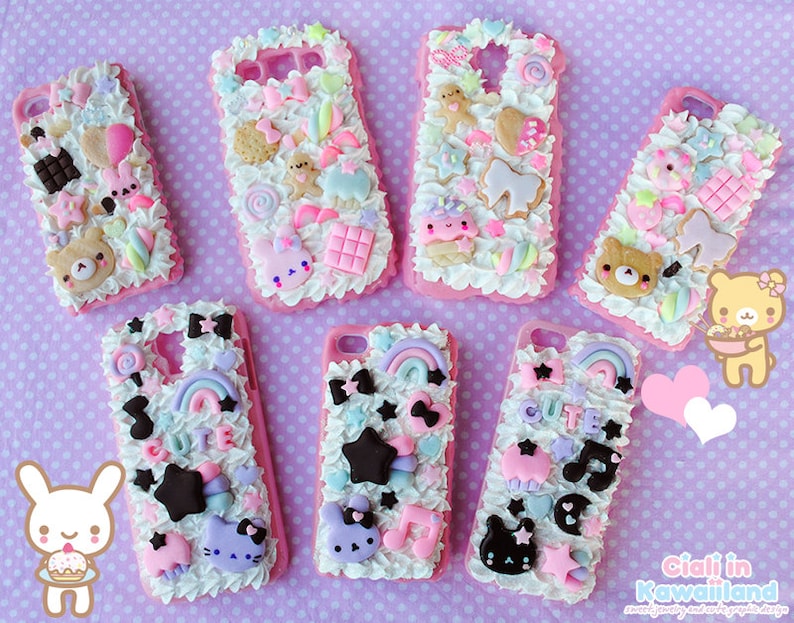 May include: Seven pink and white phone cases decorated with colourful 3D embellishments, including candy, stars, rainbows, and cartoon characters. The cases are made of a soft, squishy material and have a fluffy, cloud-like texture.