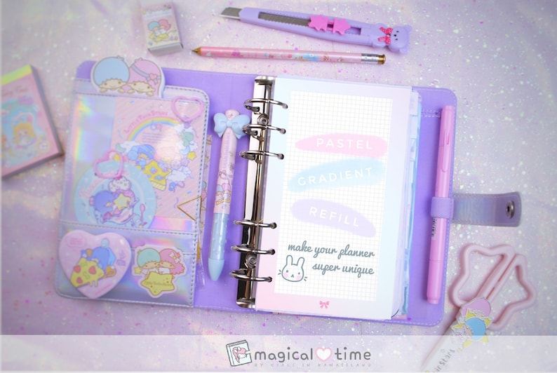 May include: A purple planner with a pastel gradient design and the text "Pastel Gradient Refill" and "Make your planner super unique". The planner has a clear pocket on the front with a rainbow design and a small bunny illustration.