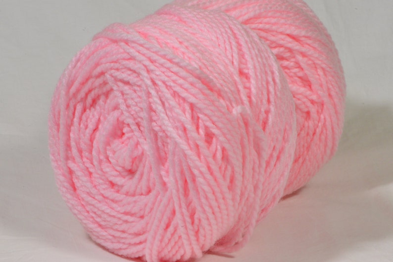 May include: A ball of soft, pink yarn. The yarn is wound into a tight coil.