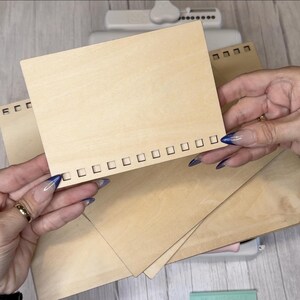 May include: Three pieces of unfinished wood with a row of square holes along the edge. The wood is light brown and has a natural wood grain.